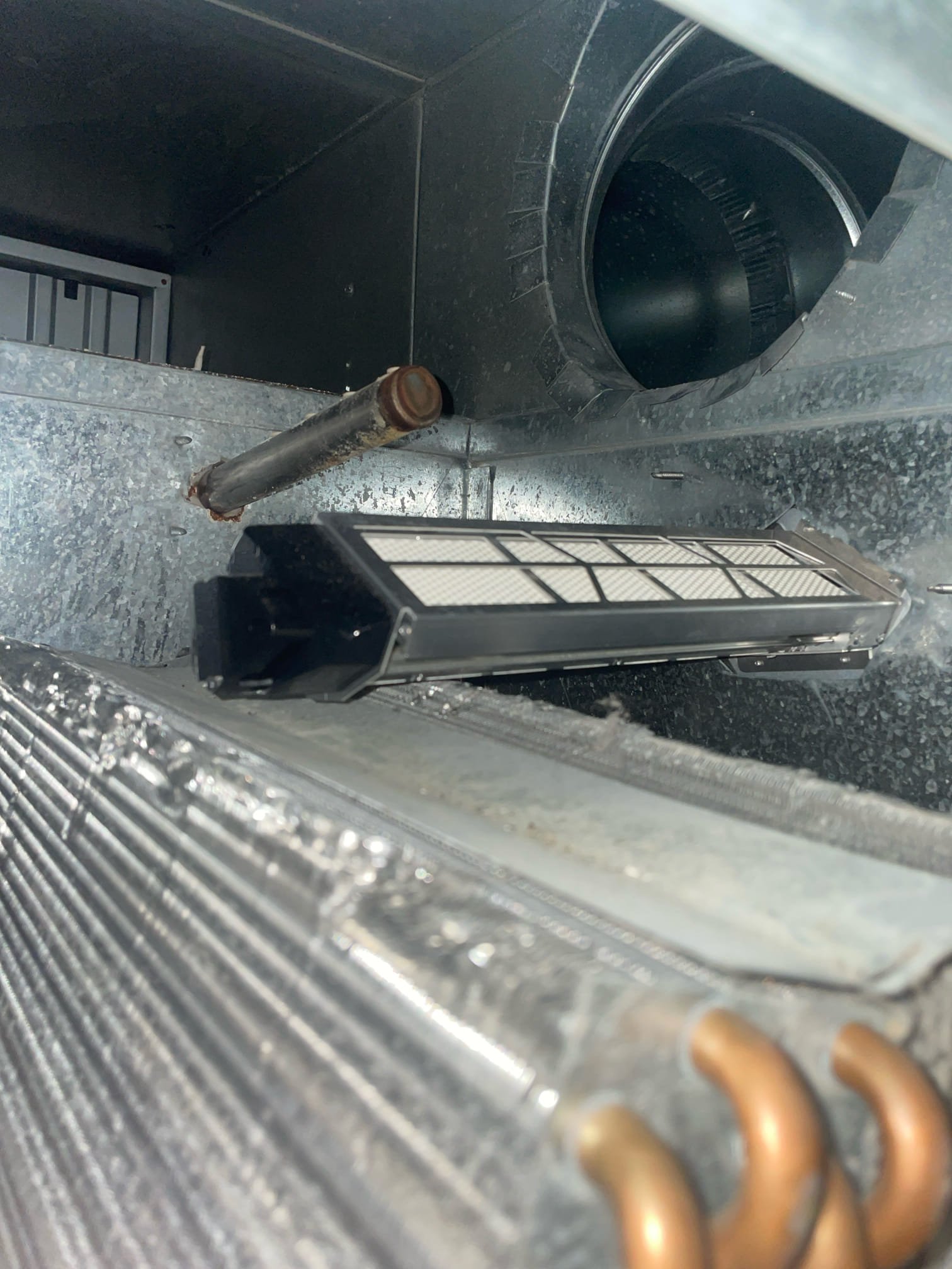 A residential furnace being serviced. Regular furnace maintenance, whether for Lennox, Payne, or other brands, ensures efficient heating. Search 'furnace tune-up near me' or 'furnace repair near me' to find local HVAC technicians.