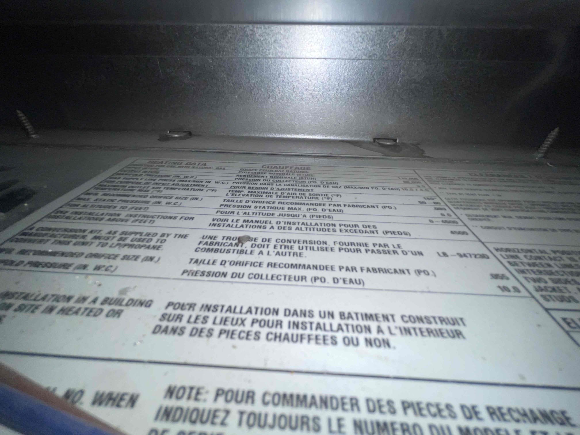 HVAC technician performing AC service repair on a home furnace. Regular furnace tune-ups and home AC repair service ensure efficient and reliable cooling and heating for your home.