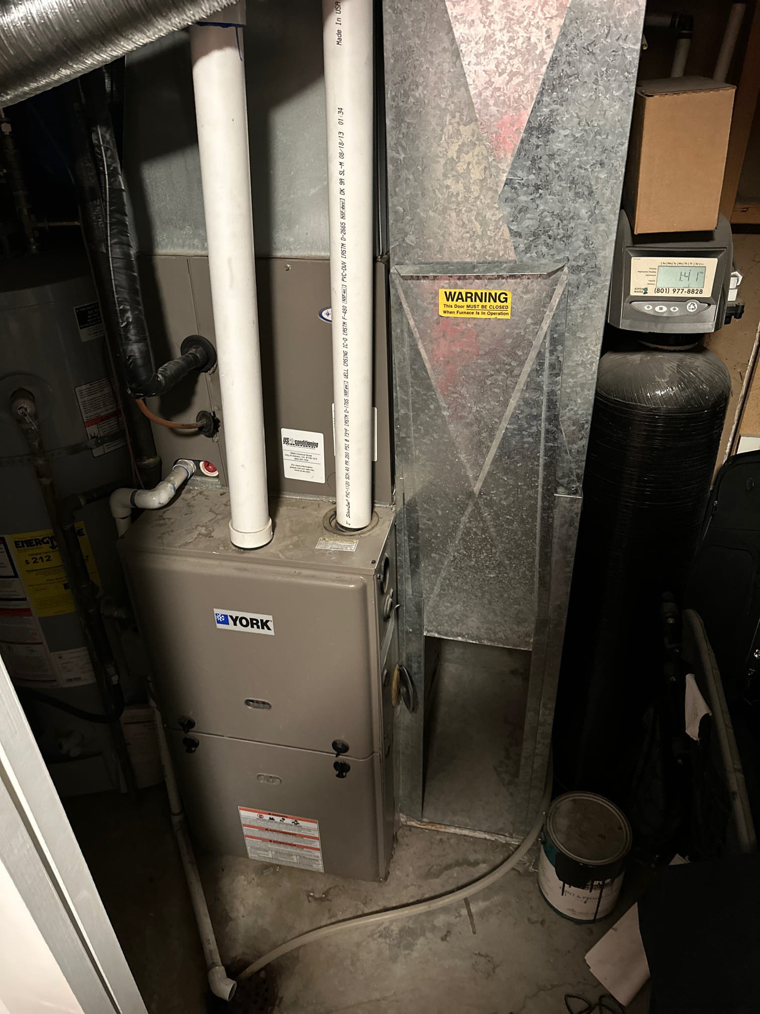 Professional commercial AC repair service utilizing a drain snake to clear a clogged AC unit. Ensuring optimal performance for your commercial air conditioning system.