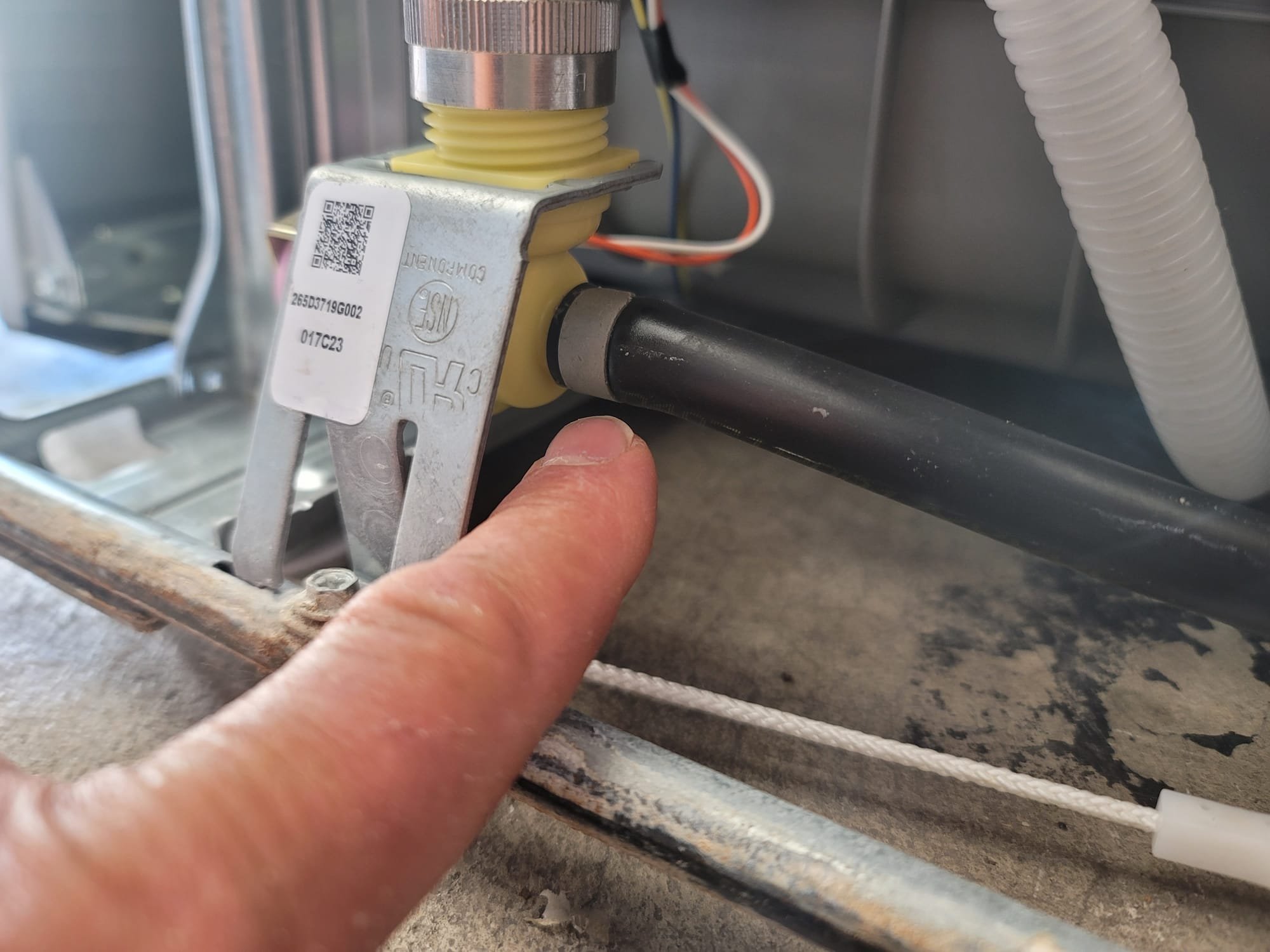 A single bathroom stall with a smelly bathroom sink. The unpleasant odor of sewage permeates the air, indicating plumbing issues or poor sanitation.