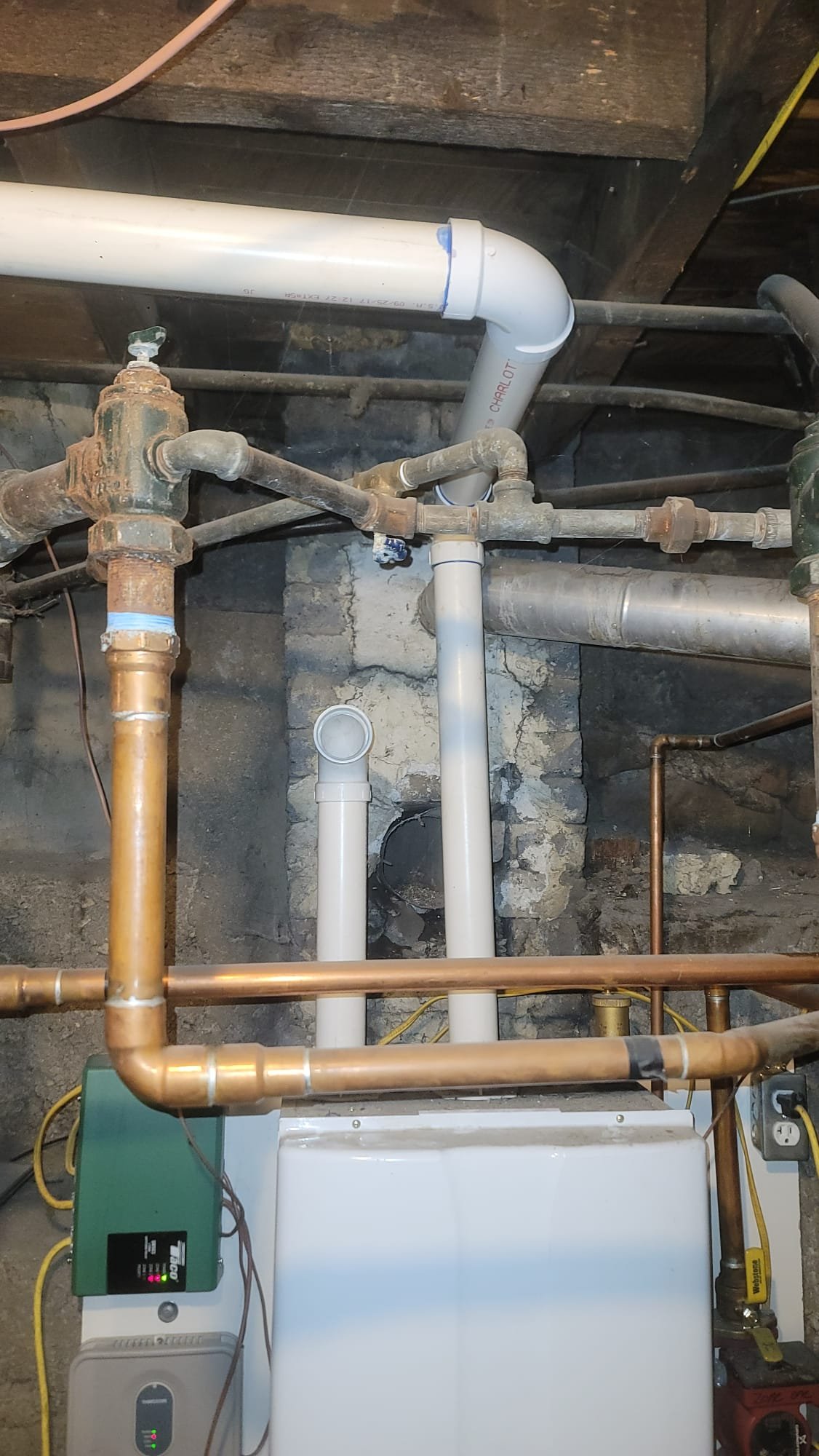 Close-up of a technician servicing a heat pump, relating to the importance of regular maintenance for efficient home heating systems, similar to boiler maintenance. Consider heat pumps when comparing furnace vs boiler options for energy-efficient heating solutions.