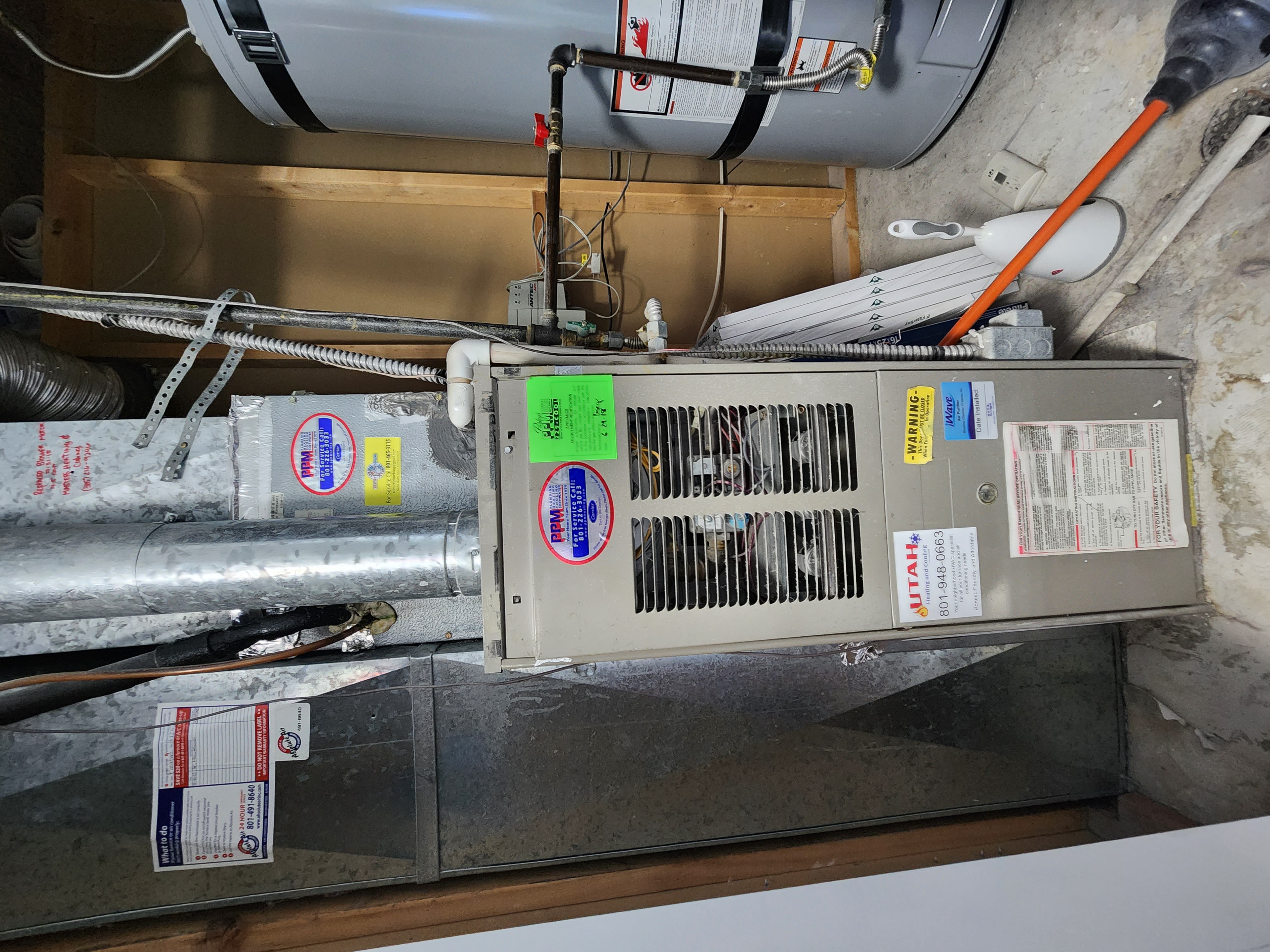 Image depicting seasonal furnace maintenance, likely fall furnace maintenance, showing a technician servicing a home furnace to ensure efficient and safe heating for the winter. Focus is on preventative care for optimal performance.