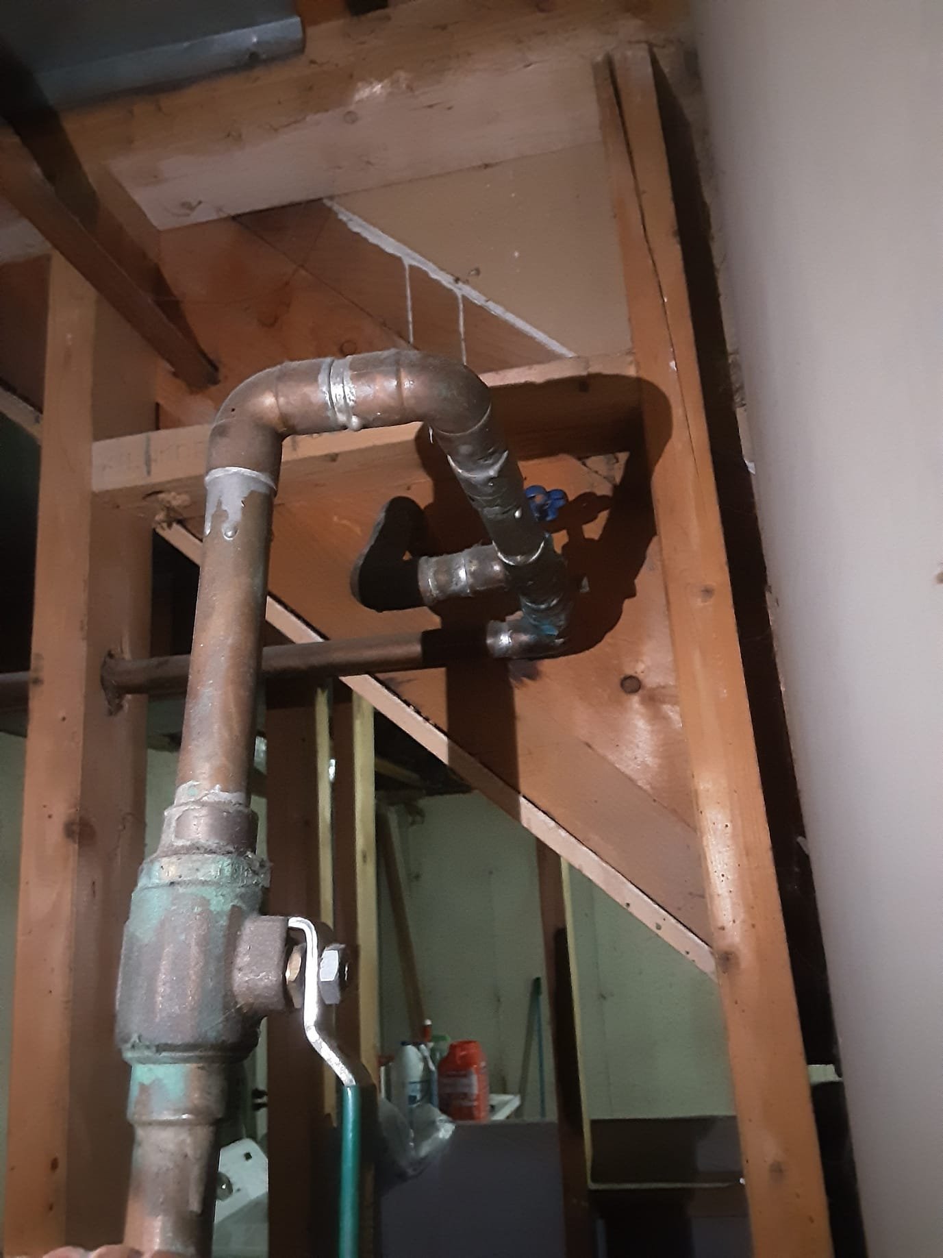 Professional plumbers expertly install a new residential water heater, highlighting services related to plumbing installation. Consider a plumbing snake rental for DIY drain cleaning or call us for complete plumbing solutions.