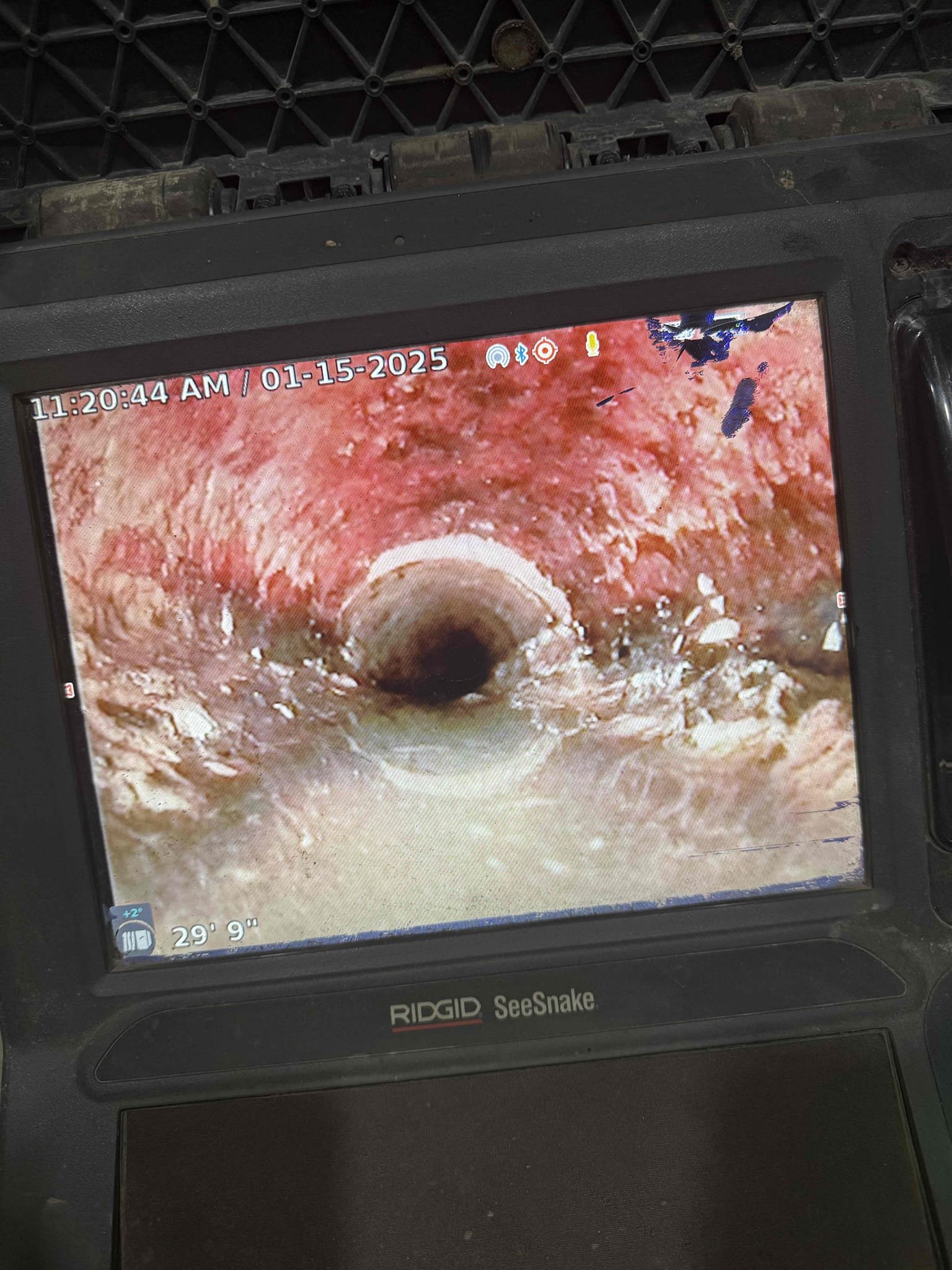 Image depicting a disaster repair inspection, possibly related to waste disposal unit repair, showcasing the work of a disaster repair service. Focus on assessment and cleanup after a disaster.