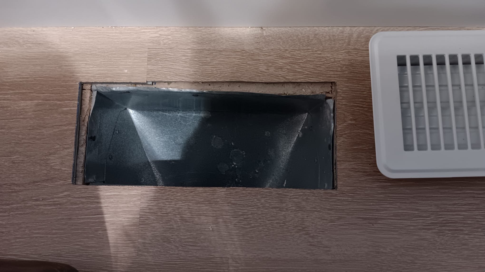 Corporate cleaners inspect a disaster cleanup site, possibly related to a clogged disposal sink. Professional cleaning services are essential for efficient and thorough restoration.