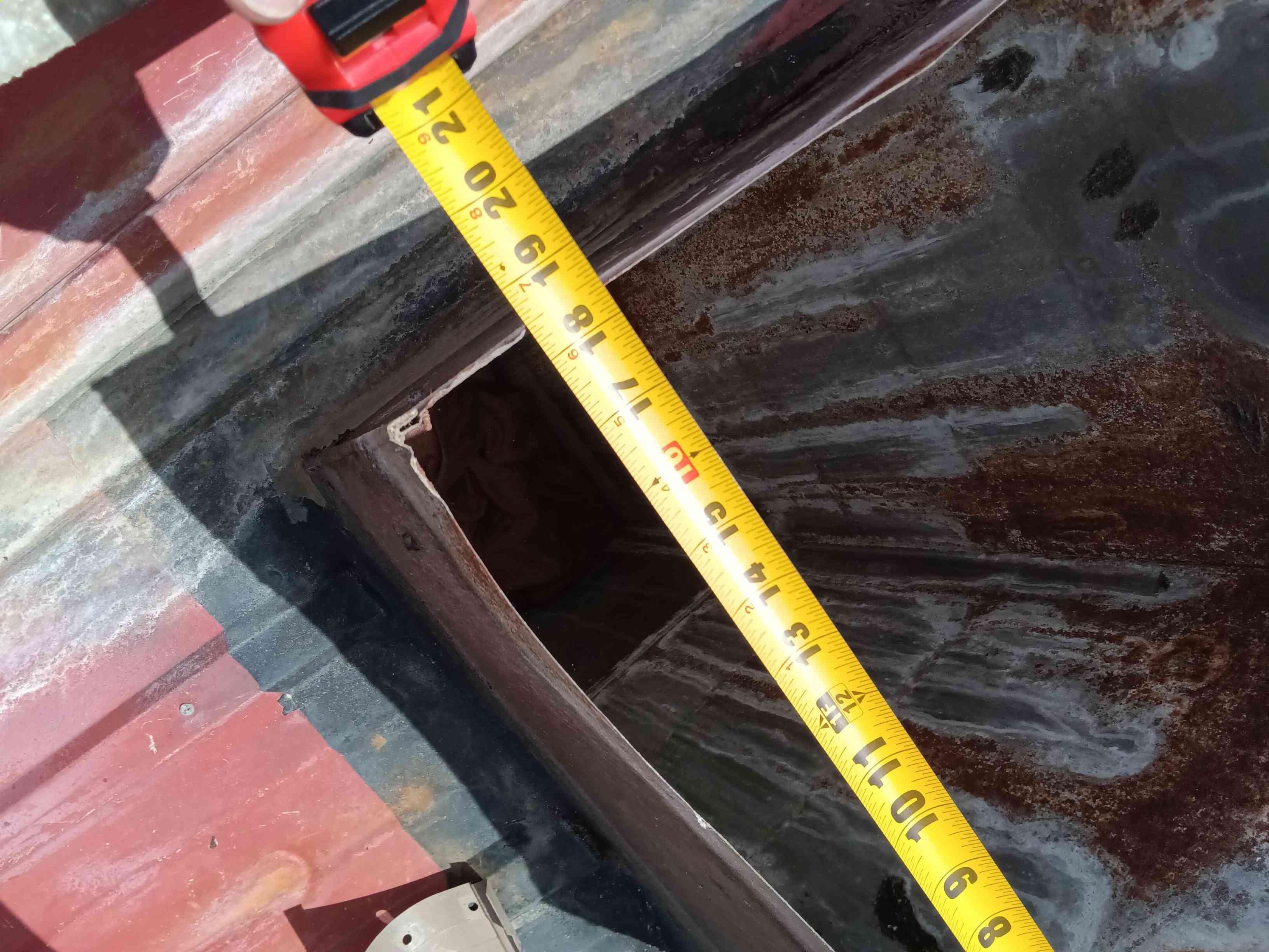 Emergency swamp cooler maintenance image. Possibly showing a technician near a swamp cooler unit, with a tool resembling a manhole sniffer, inspecting for potential issues. Search 'swamp cooler maintenance near me' for local service.