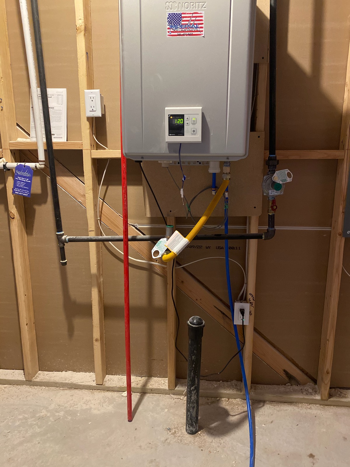 A technician repairs a tankless water heater. Image relates to local water heater installation services and the cost considerations of tankless models.