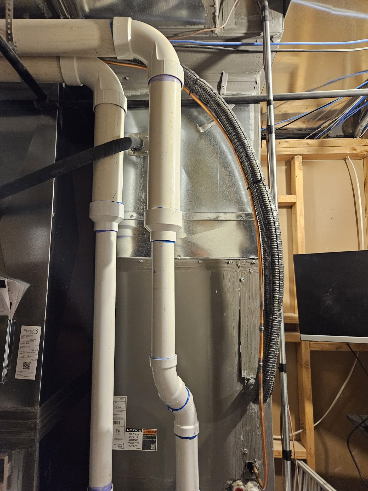 Image depicting air pollution solutions, featuring an air purifier combating indoor pollutants near home air vents. Relates to residential air quality and the costs associated with storm, disaster, and odor removal.