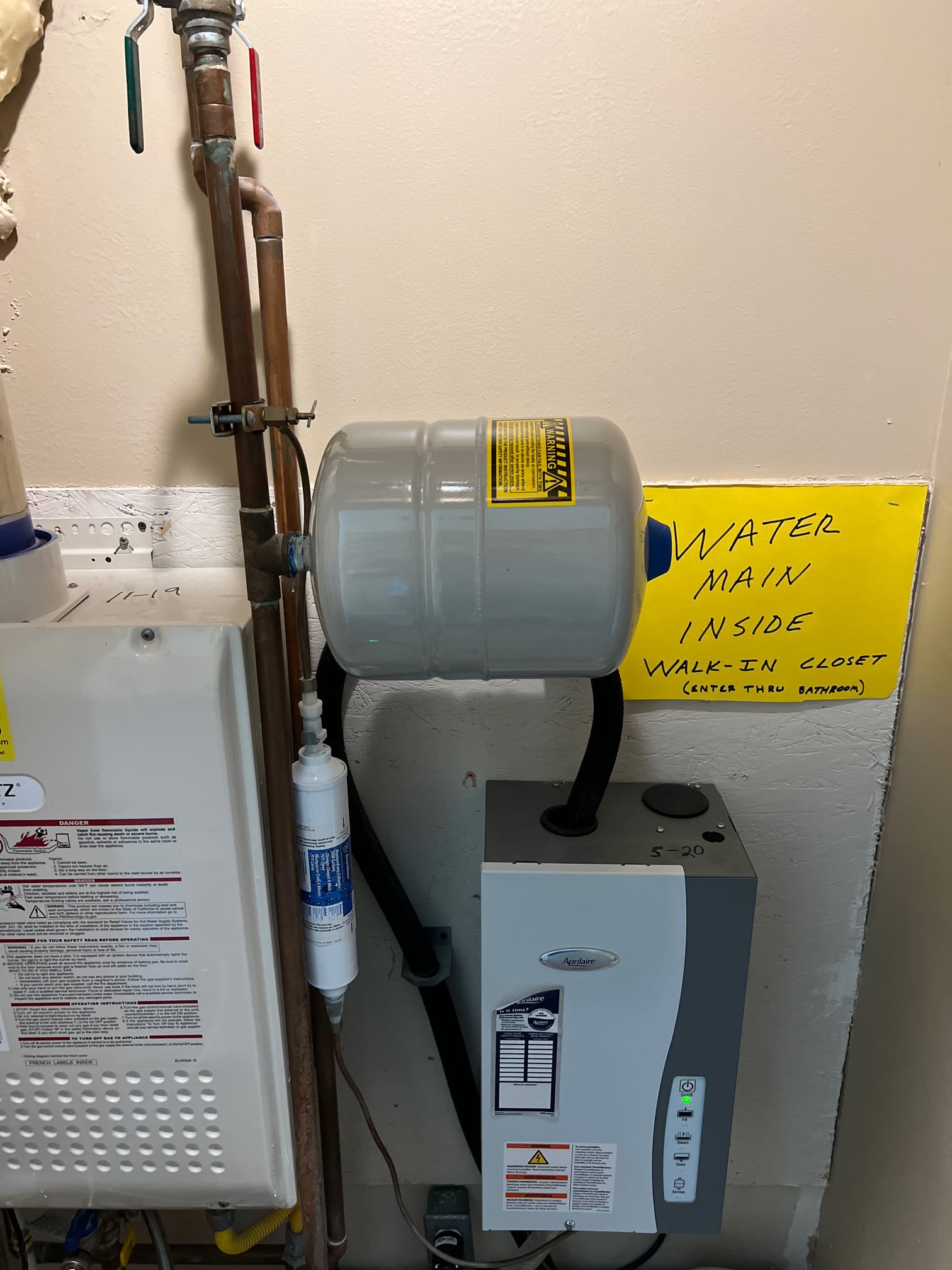 Image of plumbers installing a tankless water heater. Professionals specializing in gas tankless water heater installation and maintenance.