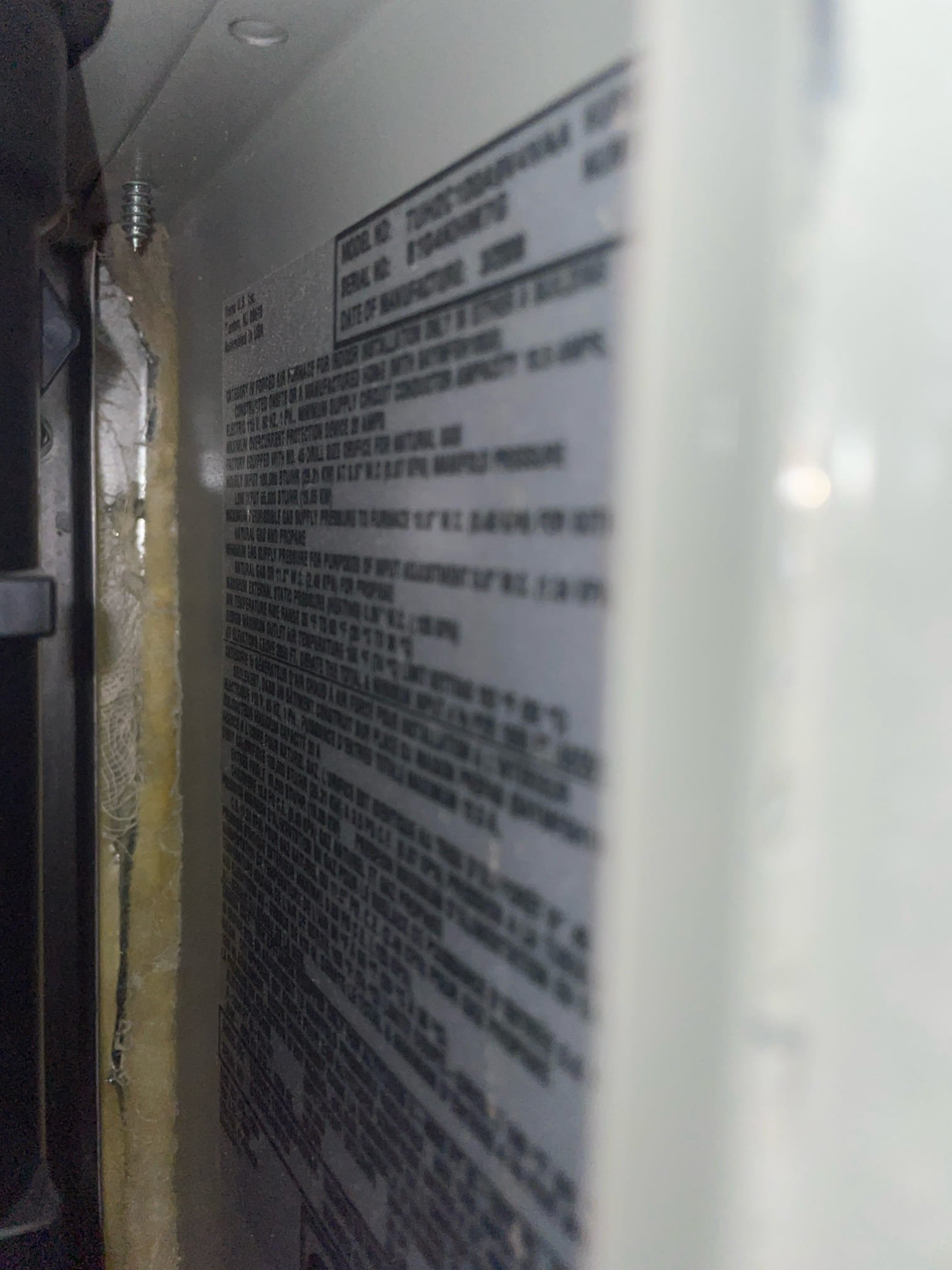 Professional HVAC technician servicing a tankless water heater. Related services include furnace tune-ups and duct cleaning for optimal home heating and energy efficiency. Find local furnace maintenance and ductwork cleaning services near you.