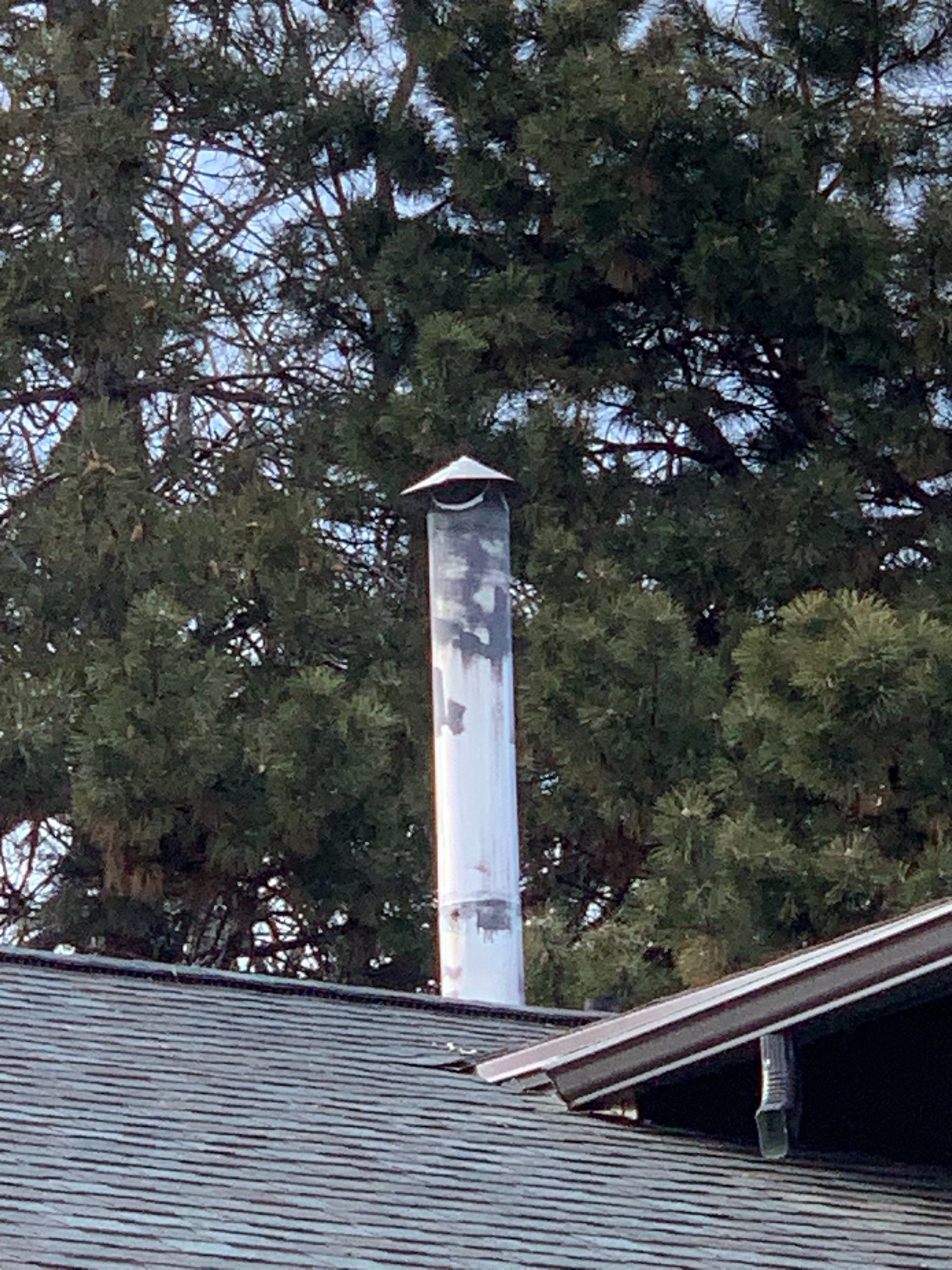 Ozone air purifier near a central air installation, promoting cleaner air alongside a new air conditioning unit for improved home air quality.