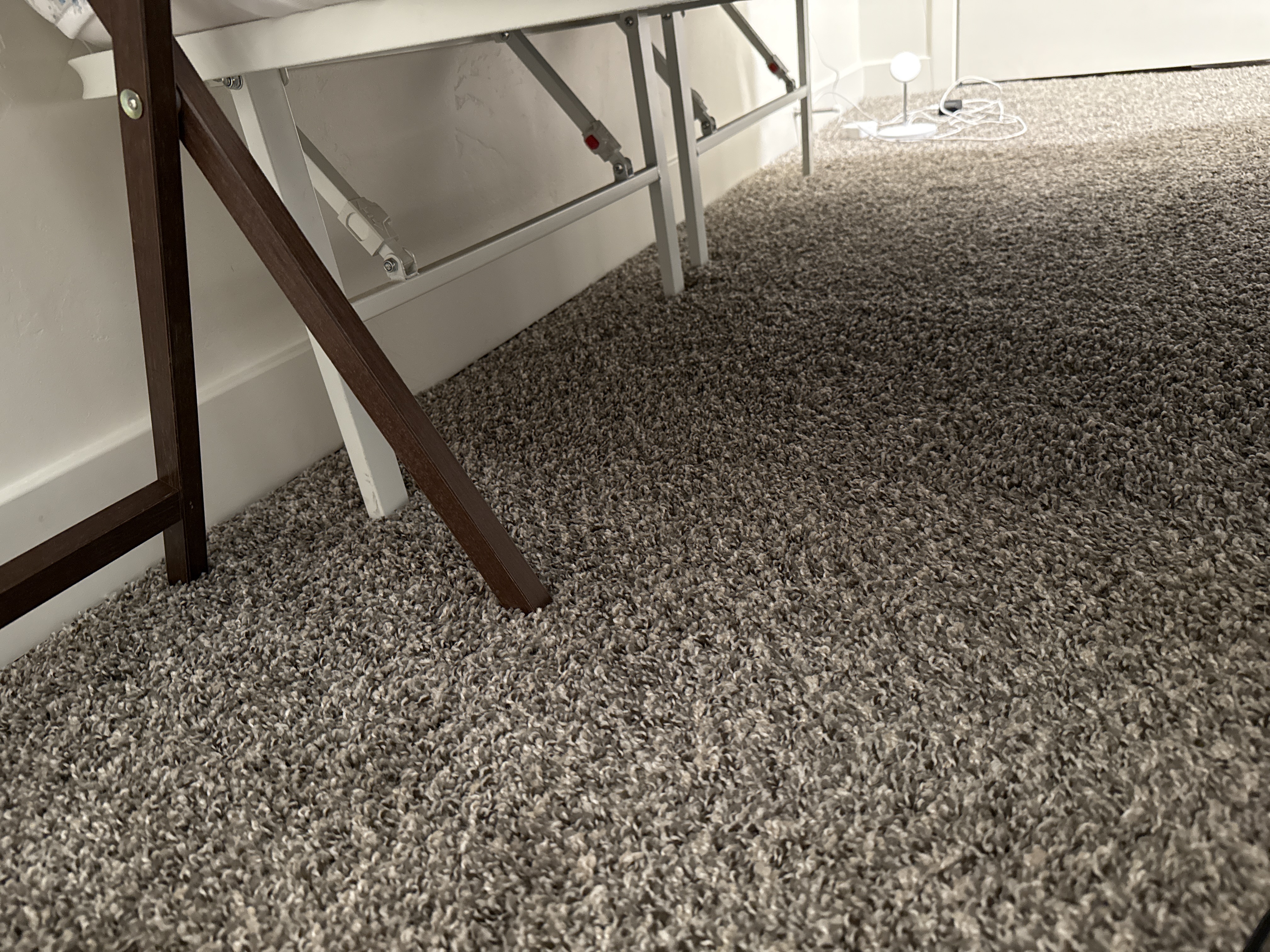 Water-stained basement ceiling after water damage, highlighting the need for cleanup and potential well water filter issues. Consider after-hours emergency services to address leaks and prevent further damage. Nearby water damage cleanup and well water filter change services available.
