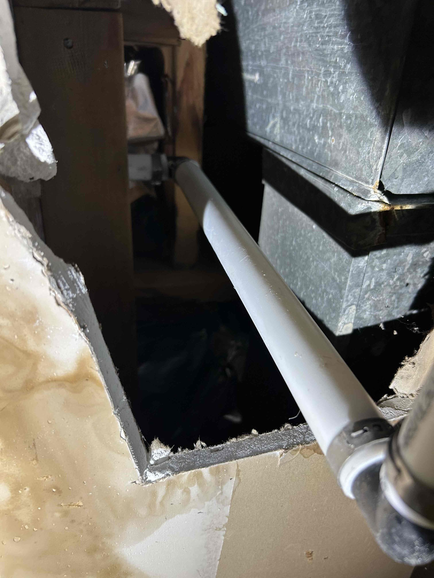 Image depicts AC condenser coil cleaning, highlighting HVAC maintenance. Relates to commercial air duct cleaning equipment and the importance of preventing issues like copper water pipe leaks through regular system upkeep.