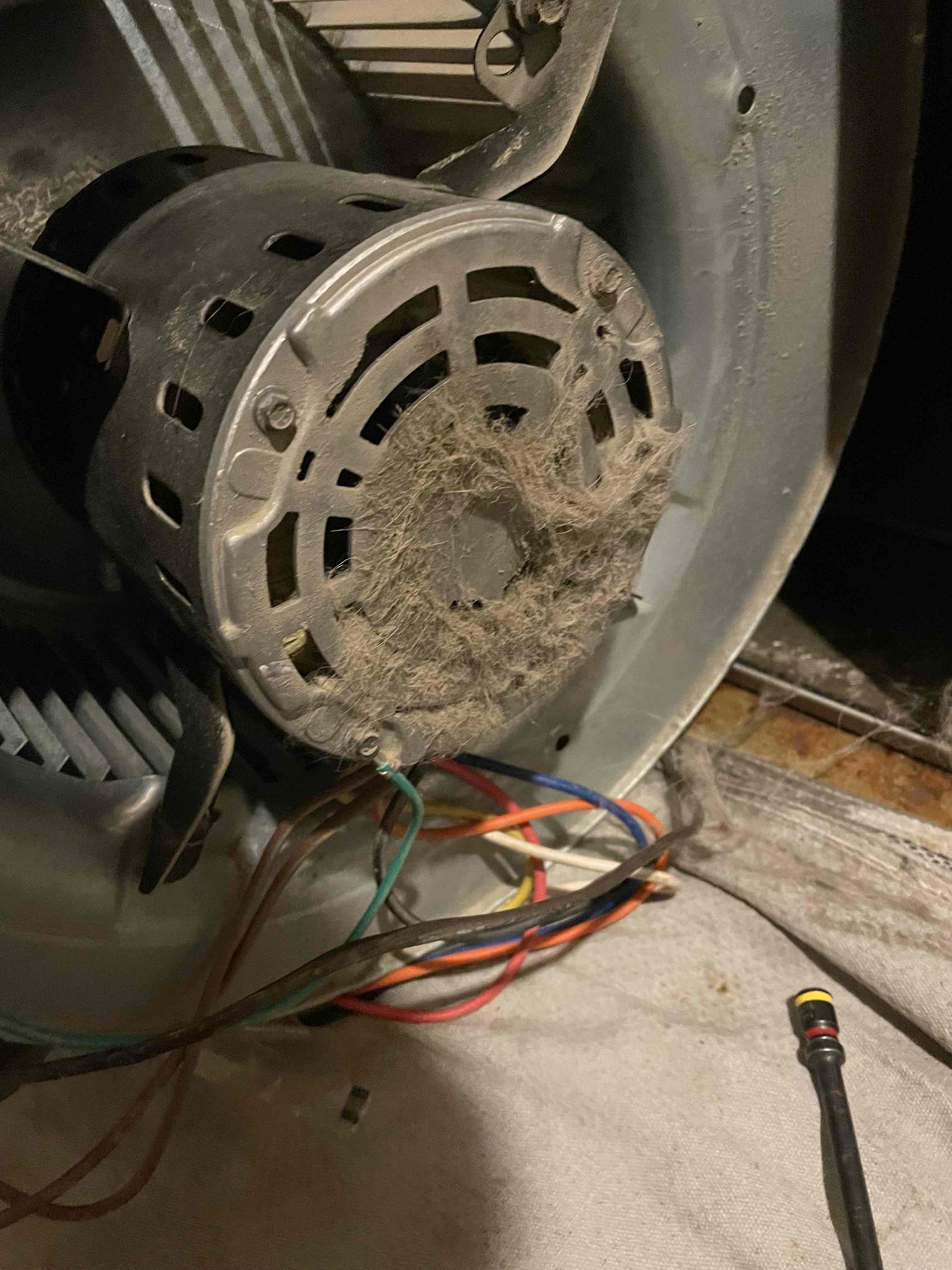 Garage AC not cooling on a hot day. A broken AC unit struggles to keep the garage cool, highlighting the need for AC repair or replacement. Problem with AC system.