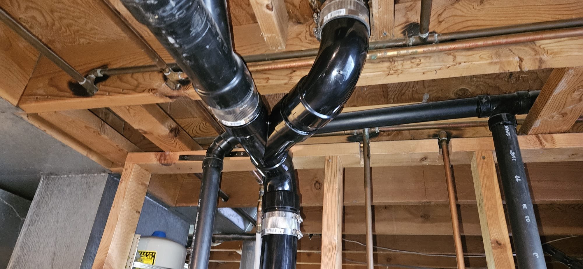 Image of plumbing tools and parts, possibly including a plumbing auger, representing plumbing tune-ups and maintenance services.