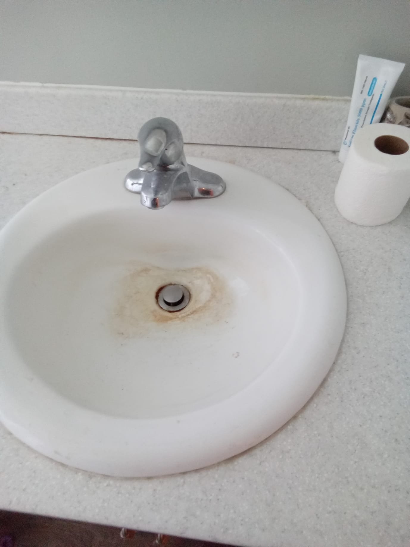 Image depicts licensed professionals performing residential flood odor removal, possibly using a sink removal tool. This relates to the overall residential flood odor removal cost, emphasizing professional service.