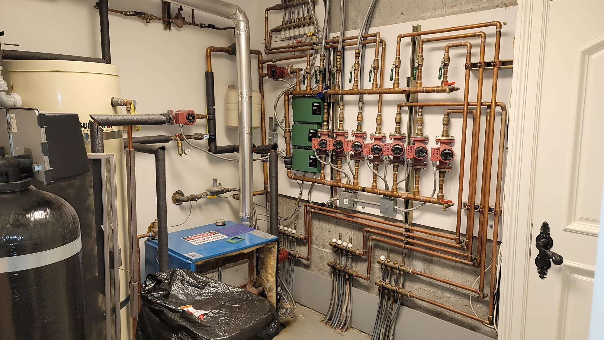 Image depicting a rainwater harvesting system connected to a water softener, highlighting the concept of purified rainwater as an alternative to filtered tap water. The system aims to prevent residential drywall water damage, acting as a proactive water damage restoration and repair solution by providing naturally soft water.