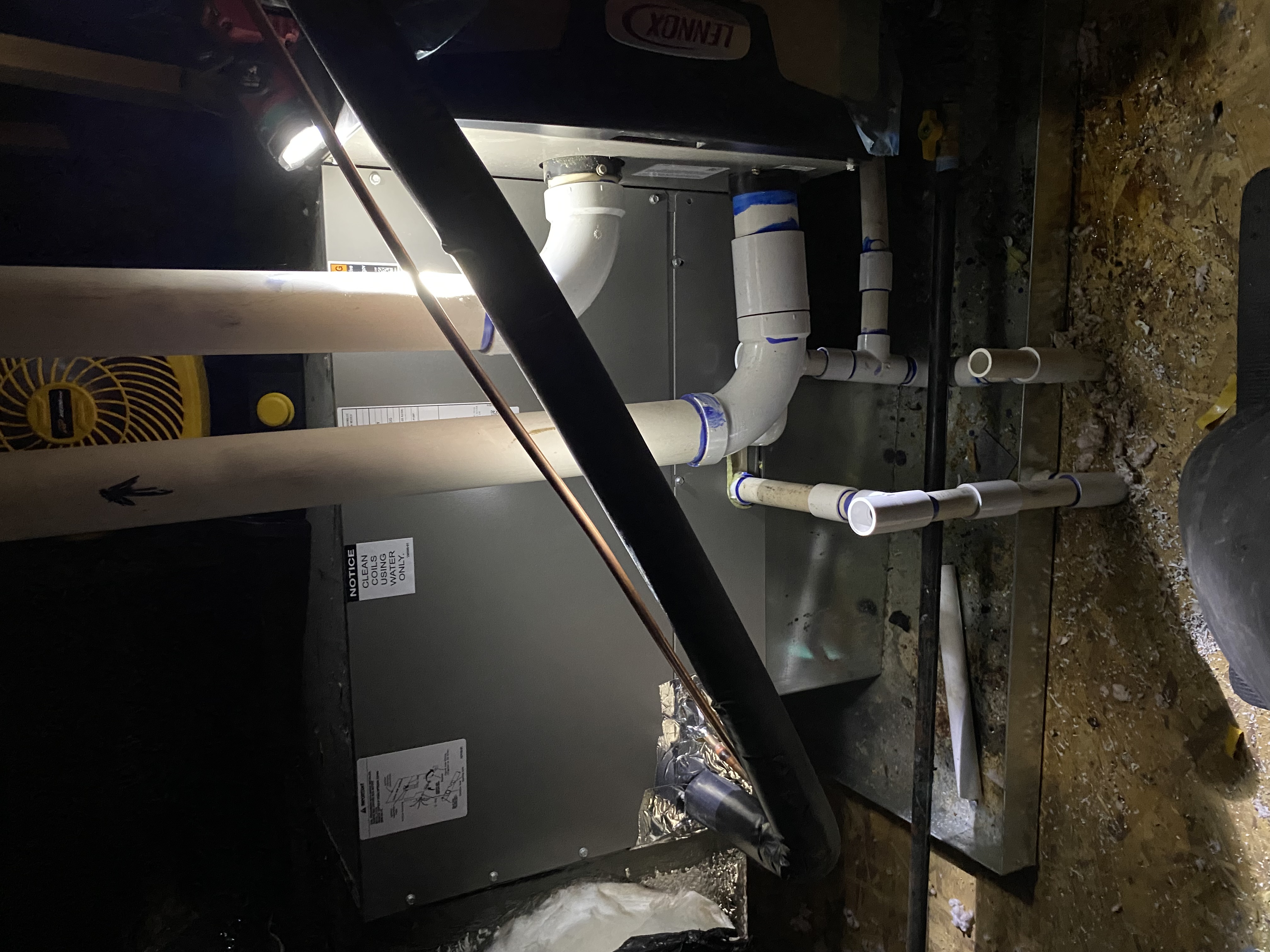 Close-up of a plumber's hands working on pipes, illustrating routine plumbing maintenance. Essential home plumbing maintenance ensures efficient systems and prevents costly repairs.