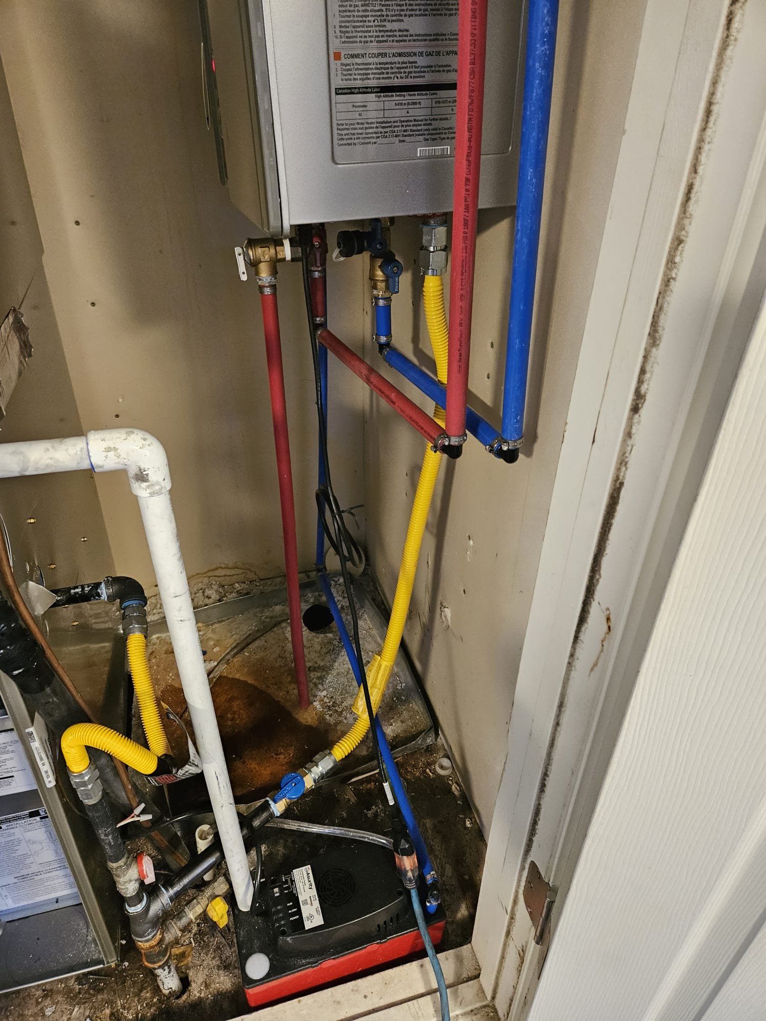 Close-up of a modern tankless water heater, highlighting its compact design and digital display, often searched for as 'electric tankless water heater near me'. Illustrates the space-saving benefits and efficiency that impact 'tankless hot water heater prices'.