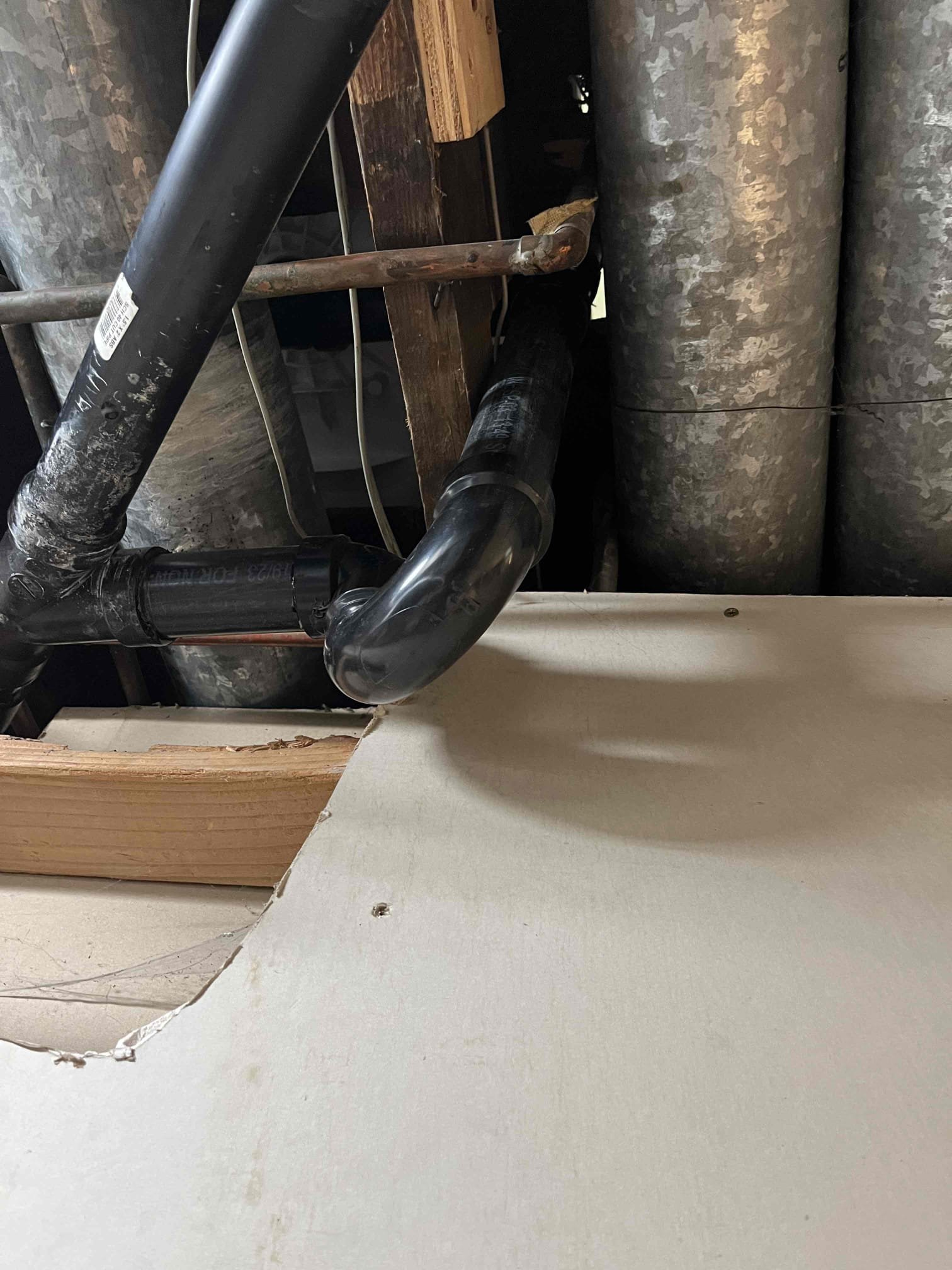 Image depicting flood recovery maintenance, possibly featuring a small outdoor wood stove being used for heating or drying after a flood. May also show signs of flood recovery services in action, such as debris removal or structural repairs. Focus on resilience and recovery after a flood event.