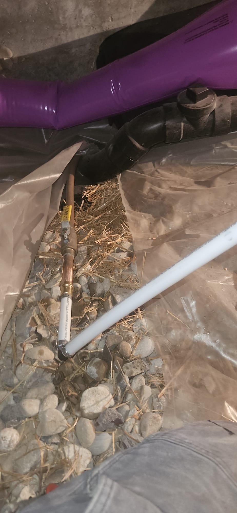 New house construction with visible plumbing, ideal for water softener system installation. Consider DIY or professional water softener installation for optimal water quality and appliance protection in your new home.