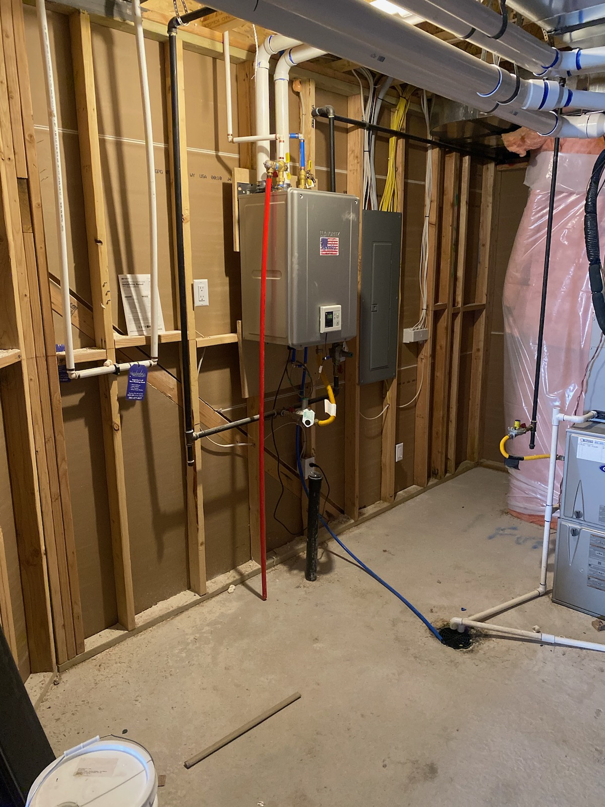 HVAC and water heater services: A house with visible HVAC unit and a glimpse of a natural gas water heater, representing local replacement and repair options for both systems.