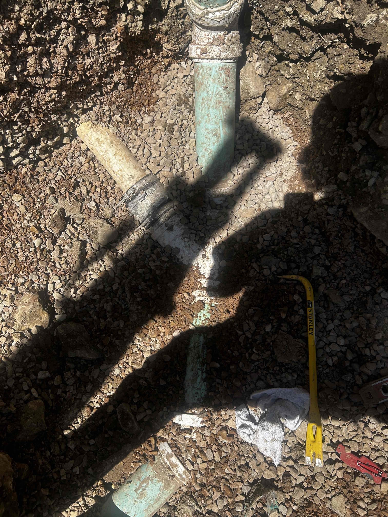 Image depicting a 24-hour plumber in Charlotte addressing a residential sewer line issue, highlighting the importance of affordable and timely sewer repair services to avoid costly damage. Illustrates a typical scenario where quick response can minimize the overall cost to fix a sewer line.