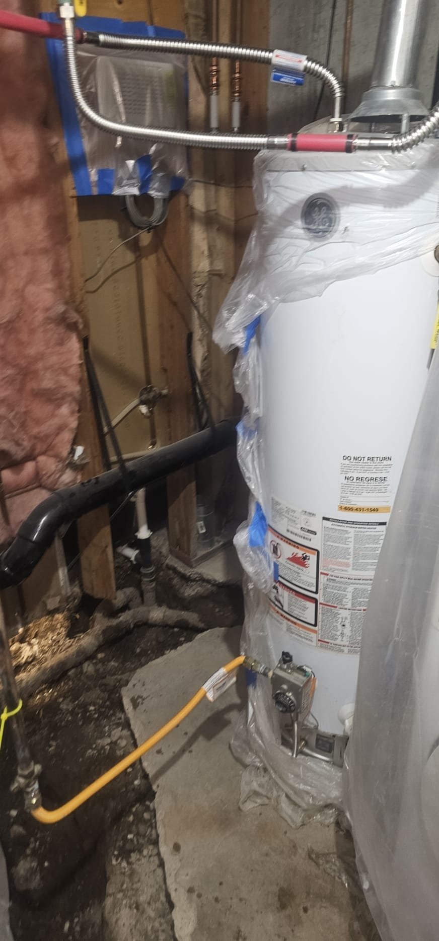 A person wearing a mask for mold abatement addresses emergency basement mold damage, highlighting the importance of safety during same-day mold remediation.