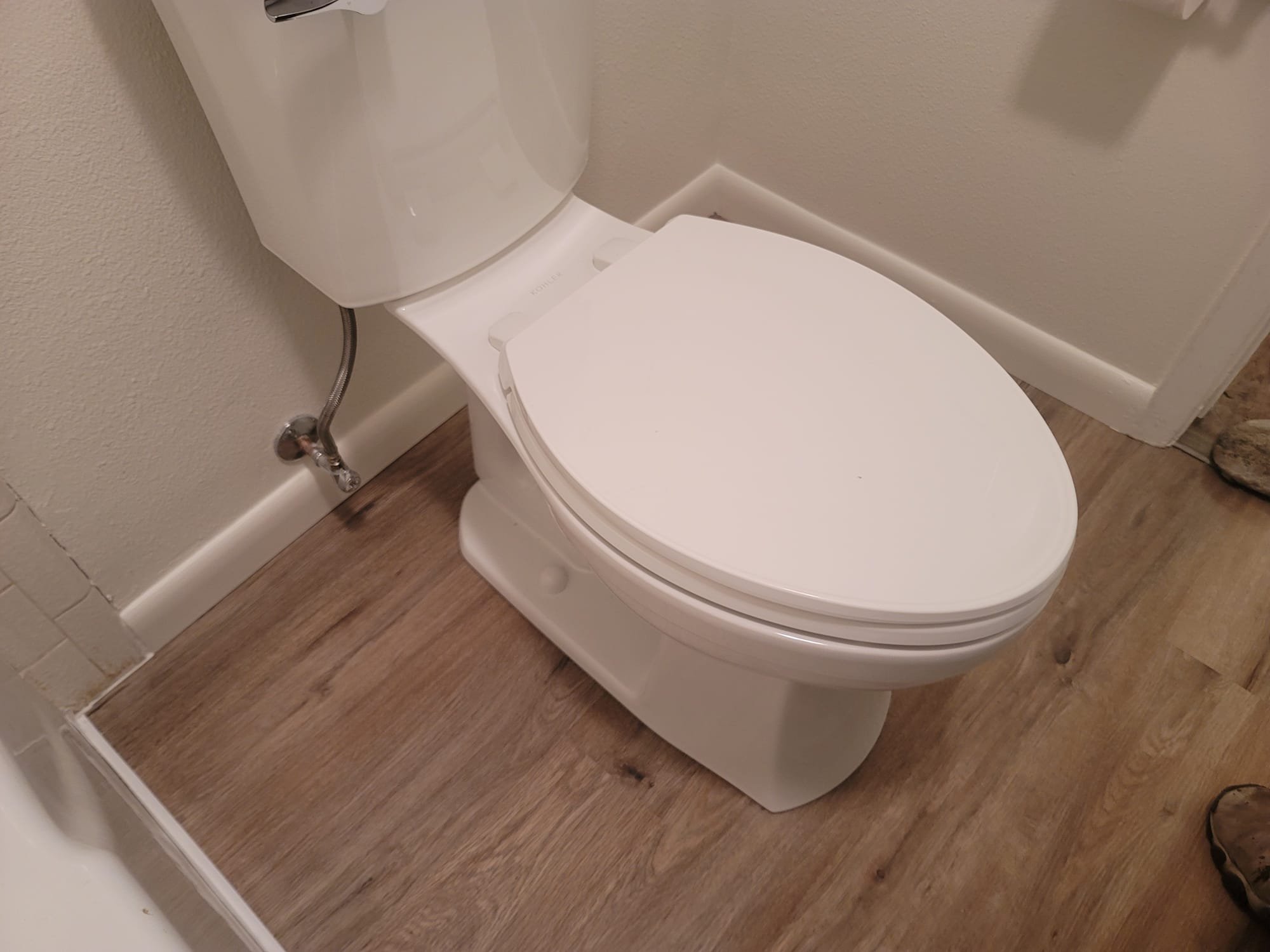 Close-up of hands replacing toilet tank parts, a common DIY plumbing task. While a leaky toilet can often be fixed with new components, major plumbing issues like a broken sewer main might require complete sewer line replacement. Understanding the costs associated with main sewer line replacement is crucial for homeowners facing extensive plumbing repairs.