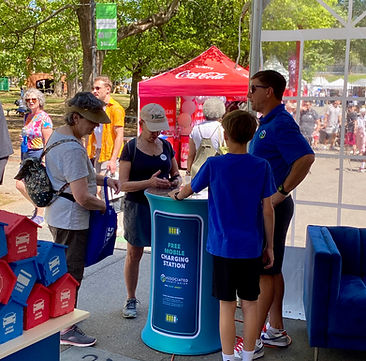 Festival with a phone charging station in Phoenix and a large crowd