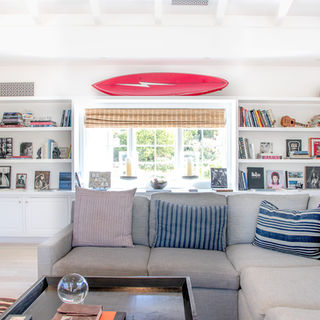 Wall of shelves in sitting room in Montecito home