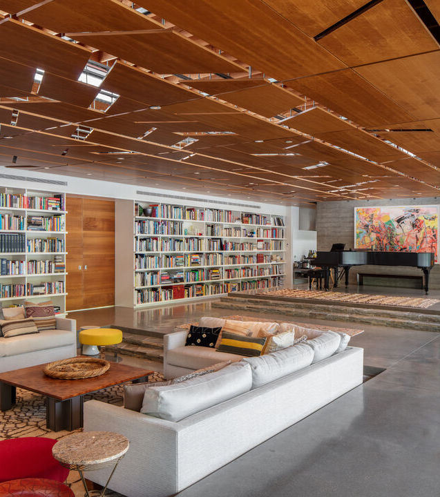 Contemporary home with bookshelves and concrete floor