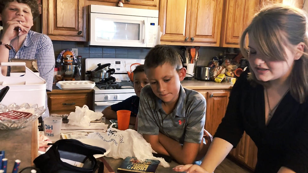 Director Haley Carr (far right) reads the run down of the script to the cast before shooting a scene.