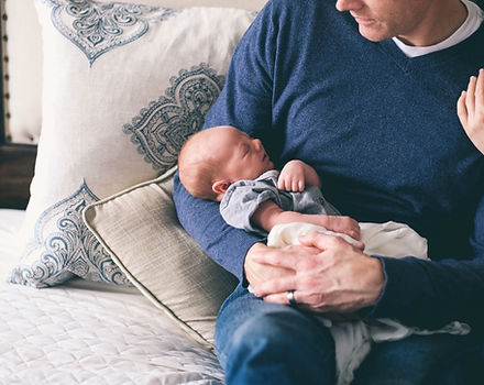 Man Holding Newborn