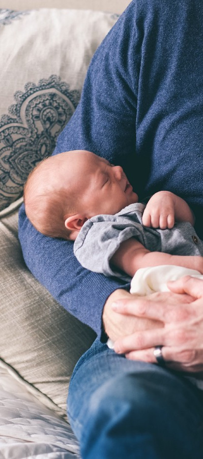 Man Holding Newborn