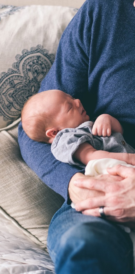 Man Holding Newborn