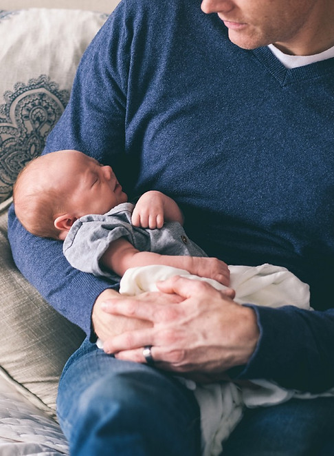 Man Holding Newborn