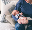 Man Holding Newborn