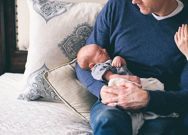 Man Holding Newborn
