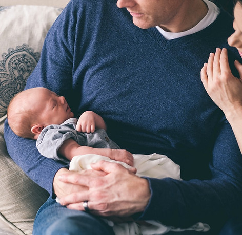 Man Holding Newborn