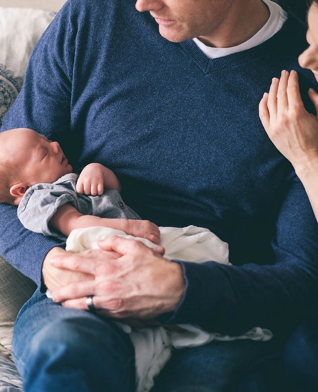 Man Holding Newborn