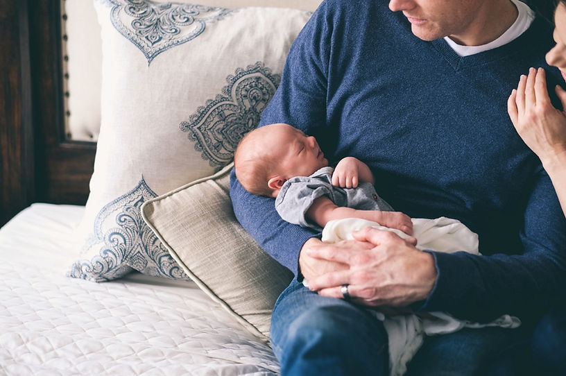 Man Holding Newborn