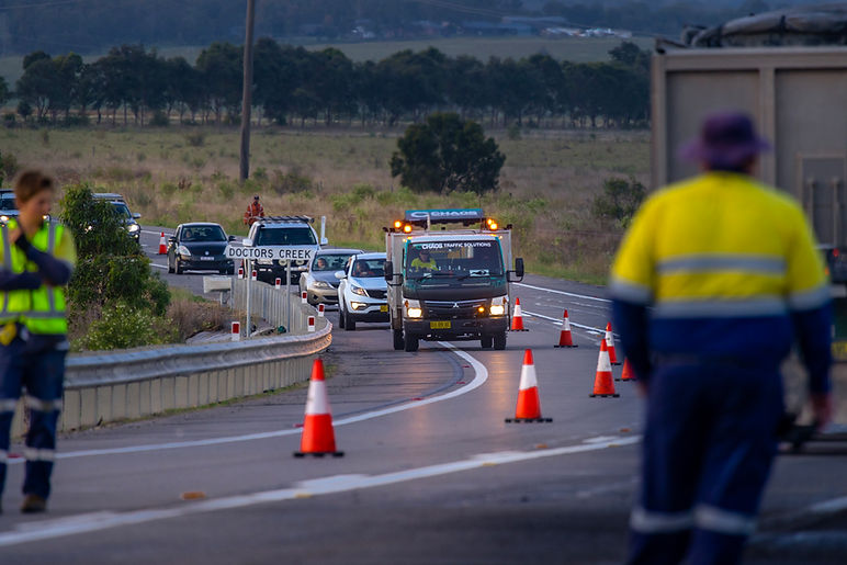 Chaos Traffic Solutions pilot vehicle escorting a queue of vehicles safely through roadworks under traffic control conditions