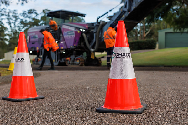 Chaos Traffic Solutions traffic control equipment positioned in front of an ANA Asphalts road profiler during pavement rehabi