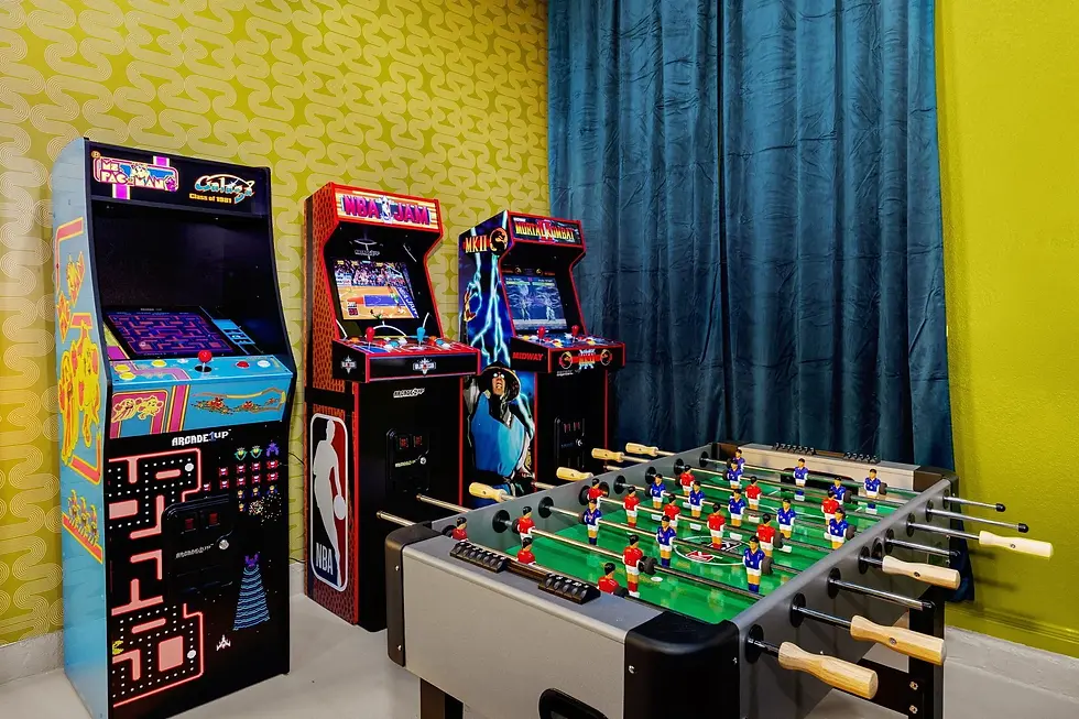 Game room with arcade games and foosball table for group entertainment at Cortado Stays