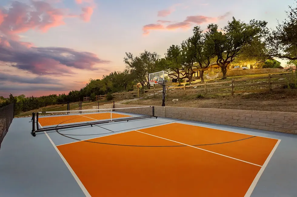Modern tennis and pickleball court at sunset at Cortado Stays vacation rental in Dripping Springs