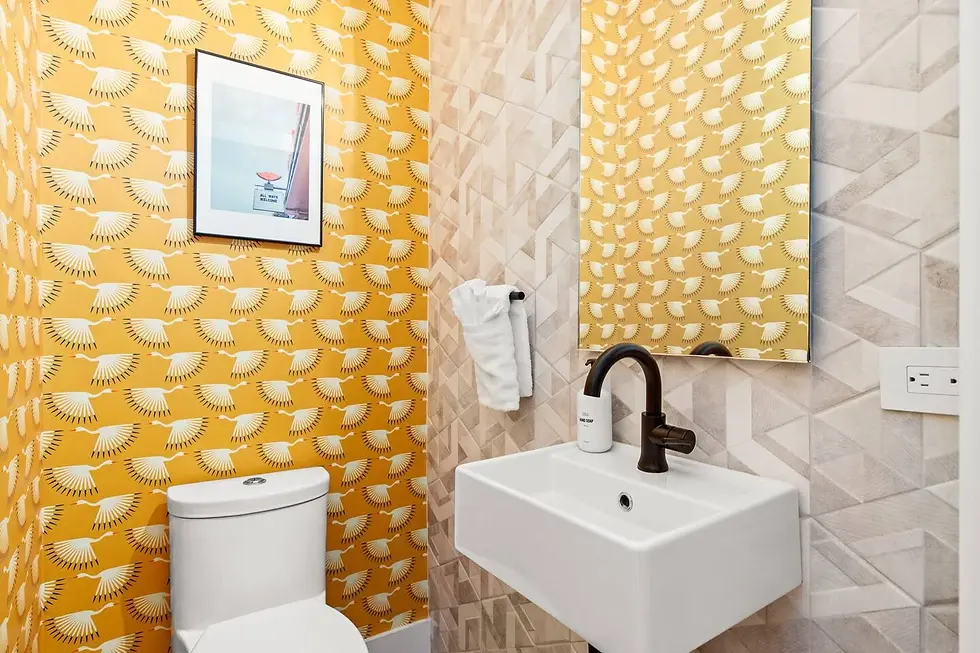 Modern bathroom with golden yellow wallpaper and designer fixtures at Cortado Villa near Austin