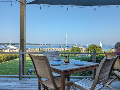 Beautiful clear blue skies dining outside with a view looking over the water
