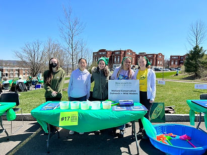 Research team outside at a table for an outreach event