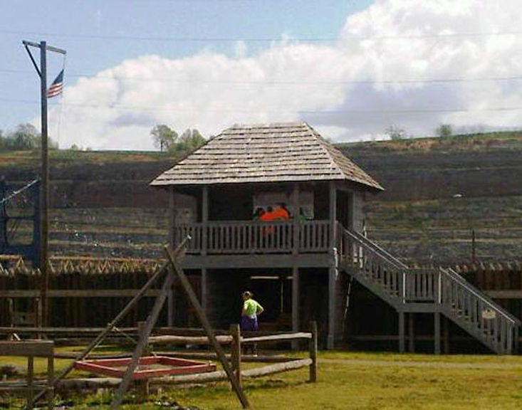 Group of people on top of the fort guardhouse, with another person underneath